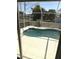 View of the screened-in pool area from inside the house at 7524 Kavanda St, North Port, FL 34287