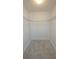 Empty walk-in closet with shelving and tile flooring, ready for personalization at 7524 Kavanda St, North Port, FL 34287