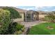 Beautiful backyard featuring a tiled patio and tropical landscaping with manicured garden at 7632 Quinto Dr, Sarasota, FL 34238