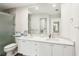 Bright bathroom with a double vanity, large mirror, and a walk-in shower with glass door at 7632 Quinto Dr, Sarasota, FL 34238