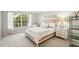 Comfortable bedroom featuring a large window overlooking lush greenery and neutral decor, creating a serene atmosphere at 7632 Quinto Dr, Sarasota, FL 34238