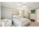 Bright bedroom with a ceiling fan, mirrored closet doors, and decor that complements the neutral color scheme at 7632 Quinto Dr, Sarasota, FL 34238