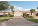 Inviting single-story home featuring a brick driveway and lush, tropical landscaping at 7632 Quinto Dr, Sarasota, FL 34238