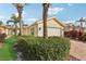 The side of a home features a well-kept garden and a brick driveway to a two-car garage at 7632 Quinto Dr, Sarasota, FL 34238