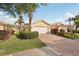 Well-maintained home boasting a brick driveway, palm trees, and vibrant landscaping at 7632 Quinto Dr, Sarasota, FL 34238