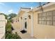 Inviting front entrance with decorative glass door, elegant pillars, and lush landscaping at 7632 Quinto Dr, Sarasota, FL 34238