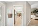 Inviting hallway view showcases a kitchen with colorful chairs, an open floor plan, and natural light at 7632 Quinto Dr, Sarasota, FL 34238