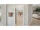 Bright hallway view into the kitchen area with stainless appliances and dining table at 7632 Quinto Dr, Sarasota, FL 34238