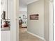 Hallway view into living area showcases wood-look floors and serene coastal decor at 7632 Quinto Dr, Sarasota, FL 34238