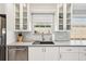 Updated kitchen with white cabinets, stainless steel appliances, subway tile backsplash, and a view from the window at 7632 Quinto Dr, Sarasota, FL 34238