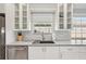 Modern kitchen featuring white cabinets, stainless steel appliances, and quartz countertops at 7632 Quinto Dr, Sarasota, FL 34238