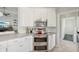 This kitchen features stainless steel appliances, white cabinetry and quartz countertops at 7632 Quinto Dr, Sarasota, FL 34238