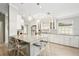 Bright kitchen with stainless steel appliances, white cabinets, a large island, and pendant lighting at 7632 Quinto Dr, Sarasota, FL 34238