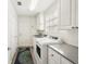 Functional laundry room with ample storage, a utility sink, and a window for natural light at 7632 Quinto Dr, Sarasota, FL 34238