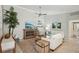 Bright living room featuring stylish decor, comfortable seating, and a contemporary ceiling fan at 7632 Quinto Dr, Sarasota, FL 34238