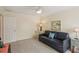 The living room features a blue sofa, ceiling fan, and a vintage wooden chest at 7632 Quinto Dr, Sarasota, FL 34238
