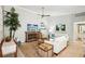 Bright living room with coastal decor, rustic wood accents, and comfortable seating area at 7632 Quinto Dr, Sarasota, FL 34238