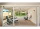 Enclosed patio with comfortable seating, a ceiling fan, and screened windows, offering a relaxing outdoor space at 7632 Quinto Dr, Sarasota, FL 34238