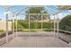 Large screened patio overlooking a well-manicured backyard with mature landscaping at 7632 Quinto Dr, Sarasota, FL 34238