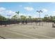 Well-maintained tennis courts surrounded by lush greenery and tall palm trees at 7632 Quinto Dr, Sarasota, FL 34238