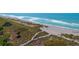 Aerial view of the beach showing the white sand and crystal-clear water at 8779 Midnight Pass Rd # 506H, Sarasota, FL 34242