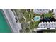 Stunning aerial of the community with beach access, pool, and lush landscaping at 8779 Midnight Pass Rd # 506H, Sarasota, FL 34242