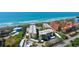 Aerial view showcasing condos with beach access, pool, and beautiful landscaping at 8779 Midnight Pass Rd # 506H, Sarasota, FL 34242