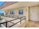 Balcony view of a condo entrance with tiled flooring and neutral tones at 8779 Midnight Pass Rd # 506H, Sarasota, FL 34242
