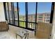 Relax on this enclosed balcony with comfortable seating and beautiful community views at 8779 Midnight Pass Rd # 506H, Sarasota, FL 34242