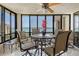 This cozy screened balcony has water views and a ceiling fan above the dining table at 8779 Midnight Pass Rd # 506H, Sarasota, FL 34242