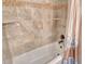 Bright bathroom with tile shower featuring tub and shower combination with tile backsplash at 8779 Midnight Pass Rd # 506H, Sarasota, FL 34242