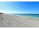 Expansive beach with soft sand and gentle waves, offering a tranquil coastal setting for leisurely walks and ocean views at 8779 Midnight Pass Rd # 506H, Sarasota, FL 34242