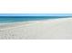 Tranquil beach scene with a gentle surf and clean, white sand at 8779 Midnight Pass Rd # 506H, Sarasota, FL 34242