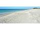 Sandy beach with blue water at 8779 Midnight Pass Rd # 506H, Sarasota, FL 34242