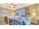 Well-lit bedroom boasts two beds, tiled floor, bedside table and large windows at 8779 Midnight Pass Rd # 506H, Sarasota, FL 34242