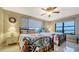 Bright bedroom featuring two beds, water view, tile floors, and ceiling fan at 8779 Midnight Pass Rd # 506H, Sarasota, FL 34242