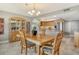 Open dining area with wood table set, chandelier and decorative hutch adjacent to kitchen with stainless steel appliances at 8779 Midnight Pass Rd # 506H, Sarasota, FL 34242