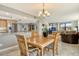 Bright dining room features granite counters, wood table set, and connects to the living room at 8779 Midnight Pass Rd # 506H, Sarasota, FL 34242