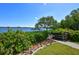 Picturesque waterfront view of a dock with lush landscaping and serene water, offering a tranquil retreat at 8779 Midnight Pass Rd # 506H, Sarasota, FL 34242
