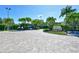 The entrance shows a brick paved road with palm trees on either side leading to the Island Reef building at 8779 Midnight Pass Rd # 506H, Sarasota, FL 34242
