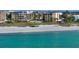 A building with a pool and beach views from the ocean at 8779 Midnight Pass Rd # 506H, Sarasota, FL 34242