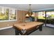 Bright game room with a pool table, chandelier, and a picturesque outdoor view through the windows at 8779 Midnight Pass Rd # 506H, Sarasota, FL 34242