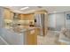 Modern kitchen featuring stainless steel appliances, light wood cabinets and marble countertops at 8779 Midnight Pass Rd # 506H, Sarasota, FL 34242