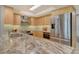 Updated kitchen with stainless steel appliances, light wood cabinets, and sleek marble countertops at 8779 Midnight Pass Rd # 506H, Sarasota, FL 34242