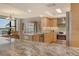 Bright kitchen with marble countertops and stainless steel appliances open to dining area with scenic views at 8779 Midnight Pass Rd # 506H, Sarasota, FL 34242
