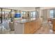 Bright condo living space with a view of the water from the large windows at 8779 Midnight Pass Rd # 506H, Sarasota, FL 34242