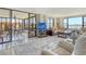Bright living room features large windows with water views and a dining area at 8779 Midnight Pass Rd # 506H, Sarasota, FL 34242