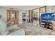 Inviting living room with sliding glass doors to balcony, neutral carpet and furnishings plus decorative built-in at 8779 Midnight Pass Rd # 506H, Sarasota, FL 34242