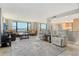 Spacious living room with tile floors, comfortable seating, and beautiful water views at 8779 Midnight Pass Rd # 506H, Sarasota, FL 34242