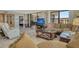Open living room features water views, plush seating, and connects to a large bedroom at 8779 Midnight Pass Rd # 506H, Sarasota, FL 34242